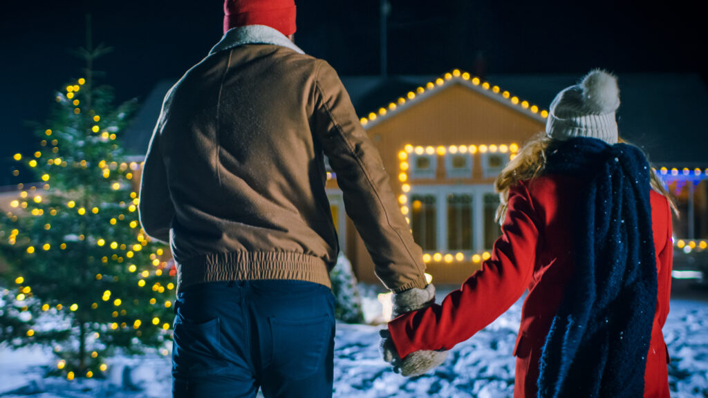 Young,Beautiful,Couple,Holding,Hands,And,Running,Through,The,Backyard