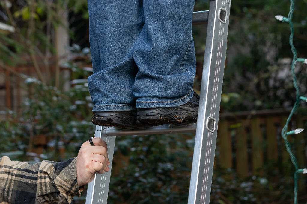 Mans,Hands,Hold,A,Silver,Ladder,Steady,So,Another,Man