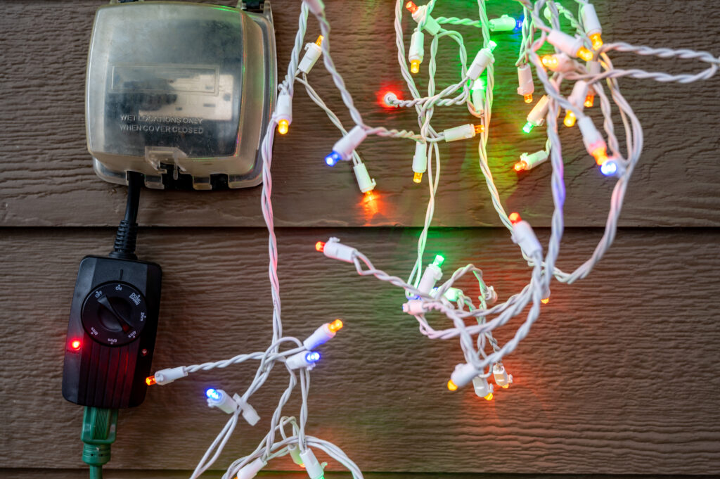 Outdoor,Timer,And,Gcfi,Outlet,With,Cover.,Blurred,Christmas,Lights